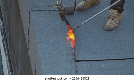 Contractors Workers Laying Roofing Felt Using Propane Gas Burner Torch Welding Bitumen Sheet