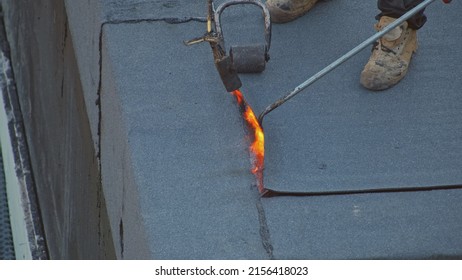 Contractors Workers Laying Roofing Felt Using Propane Gas Burner Torch Welding Bitumen Sheet