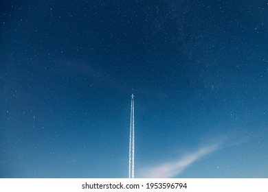 Contrail In Blue Sky. Aircraft Plane In Starry Night Sky Background. Plane Flying Up To Space With Stars On Backdrop. Travel Trip Concept. Copy Space. - Powered by Shutterstock