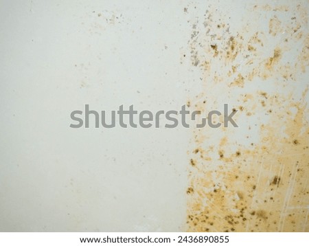 Contrast between clean and dirty. Mold and plaque on bathroom enamel. Dirt and infection. Needs cleaning. Mud cleaning concept. Yellow plaque.