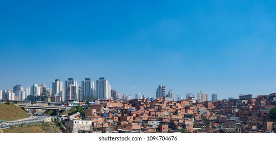 Contrast Between The Modern Buildings And Paraisopolis, One Slum Of Sao Paulo In Brazil. Example Of Gentrification In The City.