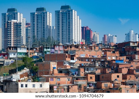 Contrast between the modern buildings and Paraisopolis, one slum of Sao Paulo in Brazil. Example of gentrification in the city.