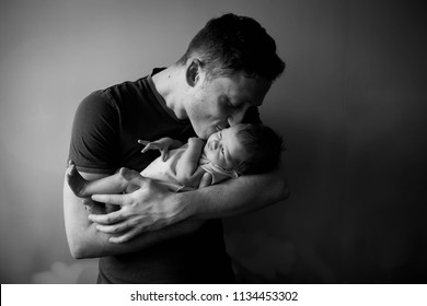 Contrast Black And White Photo, Young Father Holding A Newborn Boy, Soft Focus