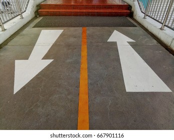 Contrast White Arrows Street Sign Walk Way With Orange Line At The Foot Bridge  To The Department Store.
Sign Background Concept.