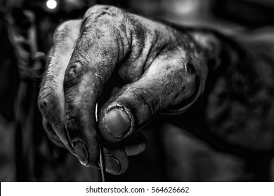 Contrasting Detail Of Hard Worker´s Hand Holding A Coffee Spoon