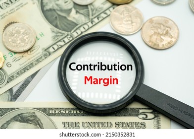 Contribution Margin.Magnifying glass showing the words.Background of banknotes and coins.basic concepts of finance.Business theme.Financial terms. - Shutterstock ID 2150352831