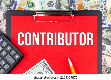 CONTRIBUTOR - word on the background of money (dollars), a notepad and a pen with a calculator. Business concept (copy space).