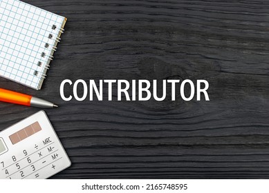CONTRIBUTOR - word (text) on a dark wooden background, notepad. Business concept (copy space).