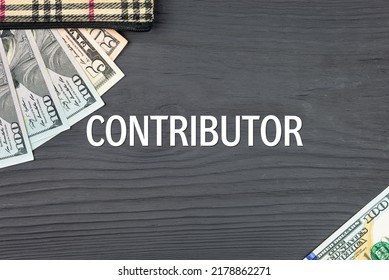 CONTRIBUTOR - word (text) on a dark wooden background, dollars, banknotes and a wallet. Business concept (copy space).