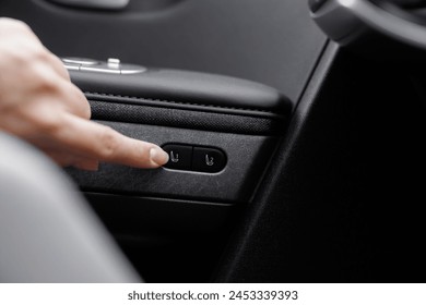Control buttons for settings and memory of the driver's seat, electric glass opening, door handle in the interior of the new luxury electric car. Driver's seat adjustment buttons.