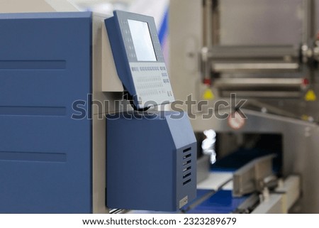 Control console of automatic industrial weigh price labeling machine. Selective focus.