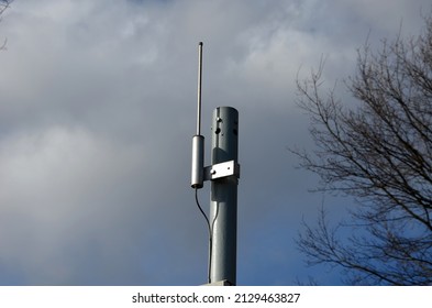 control device for adjusting and setting the traffic lights at the traffic lights at the intersection. antenna on a galvanized metal pole. sky tree