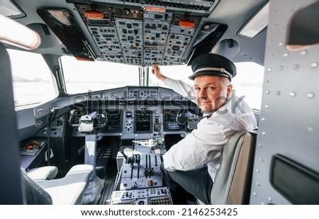 Control of the flight. Pilot on the work in the passenger airplane. Preparing for takeoff.