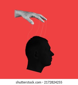 Control over human mind. Hand with strings and head on red background. Manipulation of person consciousness, thoughts, opinion. High quality photo