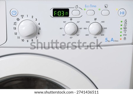 The control panel of a broken washing machine. All indicators are on and an error code is displayed. Professional washing machine repair and maintenance.