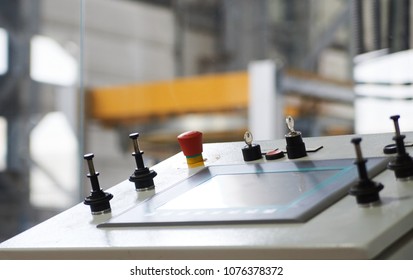 Control panel with buttons and touchscreen in control room of factory. Close-up of working process.