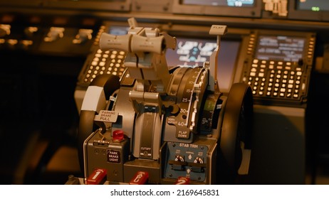 Control panel dashboard with handle or lever to throttle engine and takeoff with airplane. Power buttons and switch in cockpit to command navigation, flying on radar. Close up.