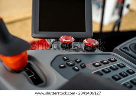 Control panel with Enter, Esc, and arrow navigation buttons inside vehicle cabin, close-up view of electronic operator interface.