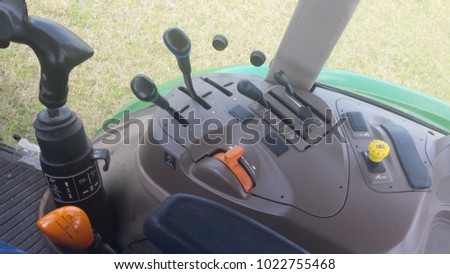 control panel inside a john deer tractor cabin 