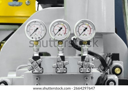Control panel with multiple high pressure gauges for monitoring the operation of hydraulic equipment of a large industrial machine. Industrial concept.