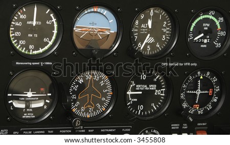 A control panel in a small airplane is filled with indicators and various controls.