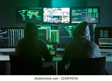 Control Room Monitoring Surveillance Video Camera Control City - Two Hooded Hackers In Dark Room Office Full Device From Secret Service Public Safety Computer Station Center. No People Indoors. 