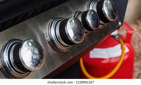 A Control Switch On A Modern Real Use Grill Smoker With Gas Cylinder In The Background