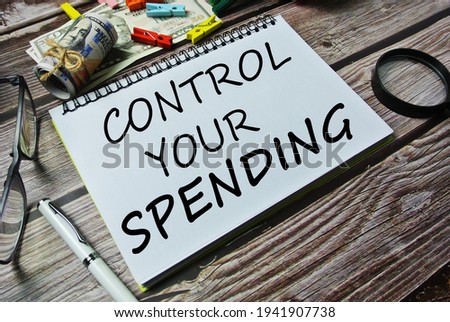 Control your spending text written in a notebook as a concept of financial, business, salary, income, tax, 401 (k) concept. Selective focus.