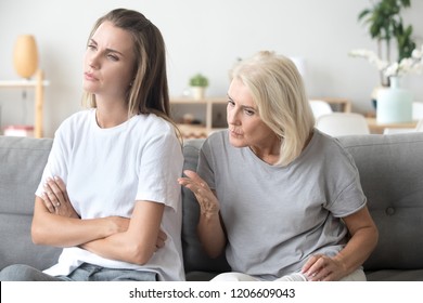 Controlling Elderly Mother Scolding Adult Daughter Having Serious Conversation With Her, Stubborn Young Woman Sit Back To Mom, Not Listening To Strict Aged Parent Lecturing Her Or Giving Advice