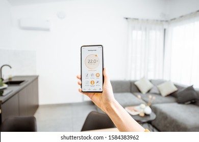 Controlling home heating temperature with a smart home, close-up on phone. Concept of a smart home and mobile application for managing smart devices at home - Shutterstock ID 1584383962