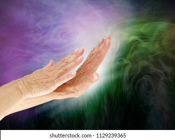 Controlling The Negative Energy Field Of An Energy Vampire - Female Hands Appearing To Push White Light Into Dark Green Depicting Energy Control 
