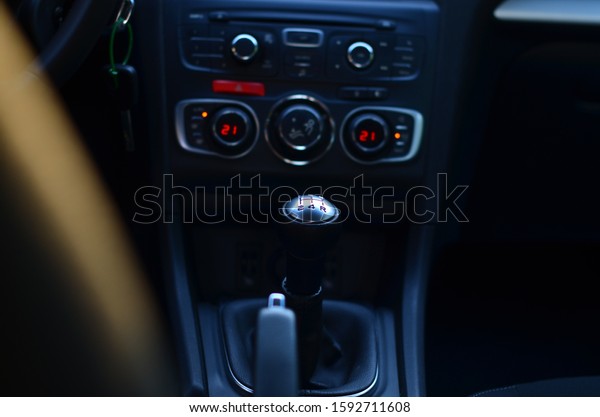 Controls for climate and audio system of the\
car. Interior of the car in black\
tones