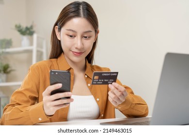 Convenience Online Internet Banking, Smile Asian Young Woman Hand In Holding Credit Card To Payment Spending
 By Scan Qr Code To Transfer Or Pay Money Without Cash At Home. Technology Of Financial.