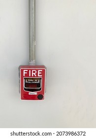 Conventional Fire Alarm Pull Station Installed On The White Wall Of The Control Room.