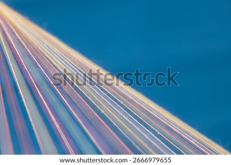 Converging Multi-colored Sewing Thread on a blue background