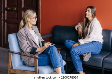 The conversation of a female psychotherapist with a woman in the office during the session. The psychologist makes a social survey of the reference group. A professional is talking to a client. - Powered by Shutterstock