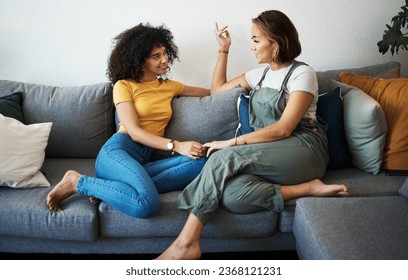 Conversation, lesbian with couple and relax on sofa in the living room talking, gossip and bonding. Happy, love and young interracial lgbtq women speaking and resting together in lounge at home - Powered by Shutterstock