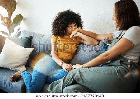Conversation, love and lesbian couple bonding on a sofa in the living room talking and relaxing. Happy, communication and young interracial lgbtq women speaking and resting together in lounge at home