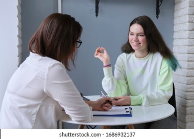 Conversation of teenage girl and woman psychologist doctor. Mental assistance to children in adolescence