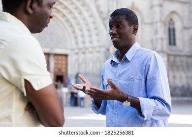 Conversation of two african americans on the street of european city on summer day