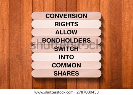 Conversion Rights Allow Bondholders Switch Into Common Shares tagline written on wooden stick with wooden texture background, business and investment, stock market theme, copy space