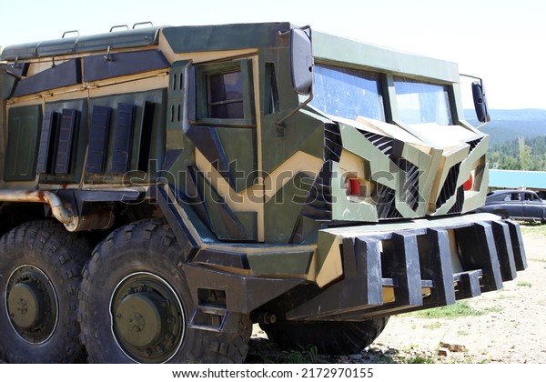 A converted cabin of a large truck in
camouflage colors.The cabin of the
truck.