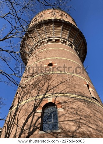 Converted Watertower Lauwerhof to Business Center, a tall red brick tower with a blue sky in Utrecht, Netherlands