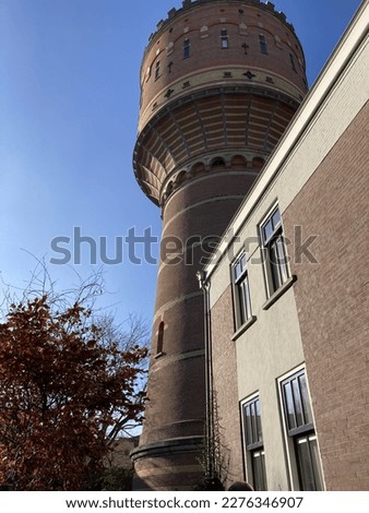 Converted Watertower Lauwerhof to Business Center, a tall red brick tower with a blue sky in Utrecht, Netherlands