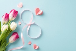 Convey Heartfelt Greetings On Woman's Day With Picturesque Arrangement: Top View Tulips, Hearts, And A Silk Ribbon Shaped Into An 8, Creating A Celebratory Scene Against A Soothing Pastel Blue Surface