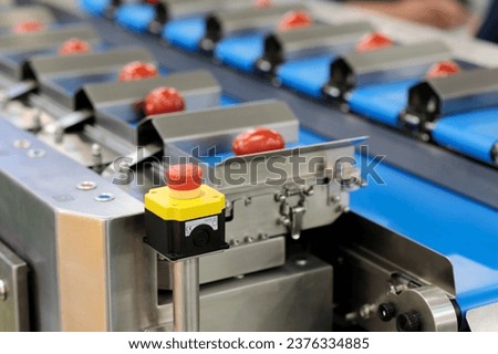 Conveyor with automatic food weighing machine. Selective focus.