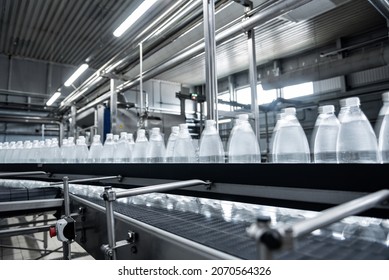 Conveyor belt with bottles of drinking water at a modern beverage plant. - Shutterstock ID 2070564326