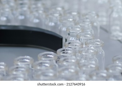 Conveyor Belt With Empty Medical Injection Glass Vials - Automatic Production Line. Pharmaceutical Industry, Manufacturing, Medicine And Automated Pharma Technology Equipment Concept