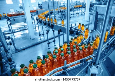 Conveyor belt, juice in bottles on beverage plant or factory interior in blue color, industrial production line, toned