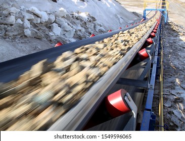 Conveyor belt moves ore from the quarry for processing. Blurred foreground